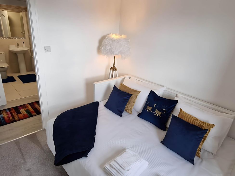 A bedroom with a bed and lamp at 36 Deas Wharf Kirkcaldy