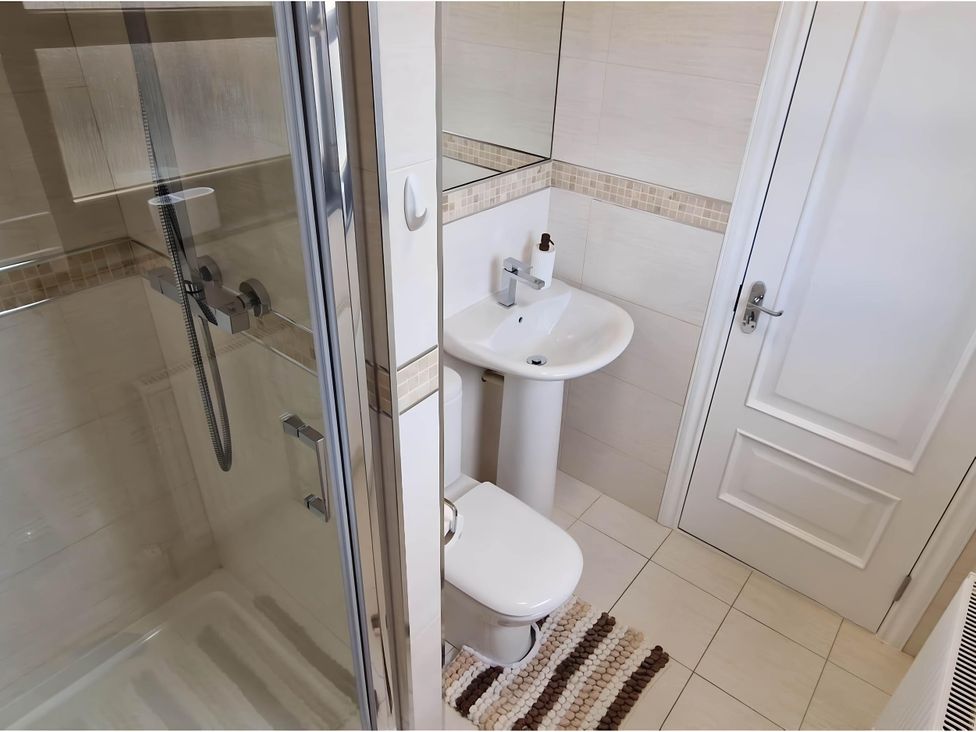A bathroom with a shower, toilet, and sink at 36 Deas Wharf Kirkcaldy