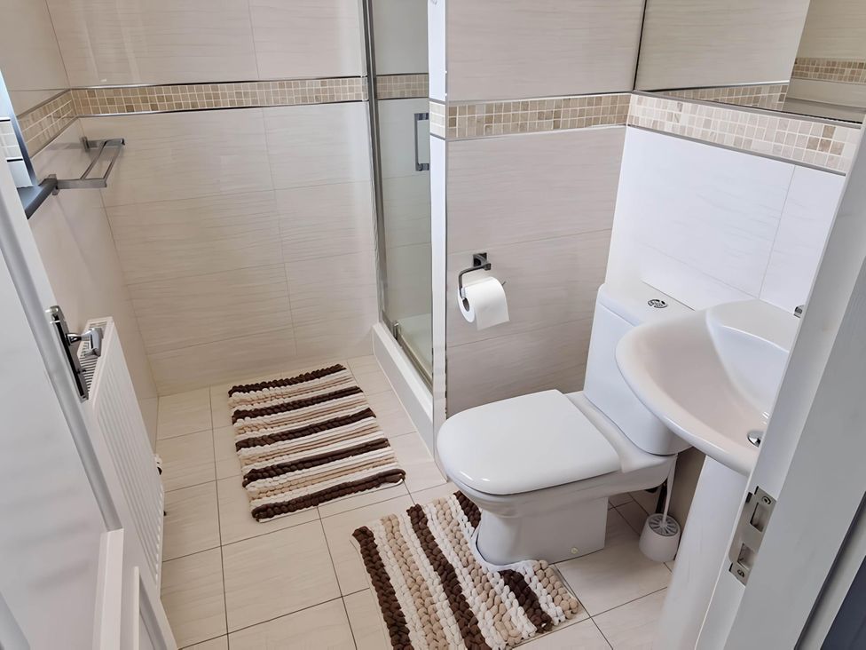 A bathroom with a shower, toilet, and sink at 36 Deas Wharf in Kirkcaldy