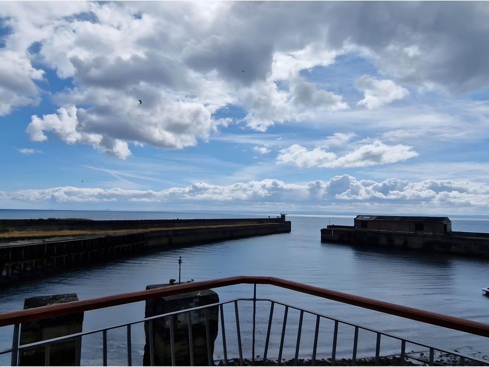 A view of the harbor with a pier and clouds at 36 Deas Wharf in Kirkcaldy