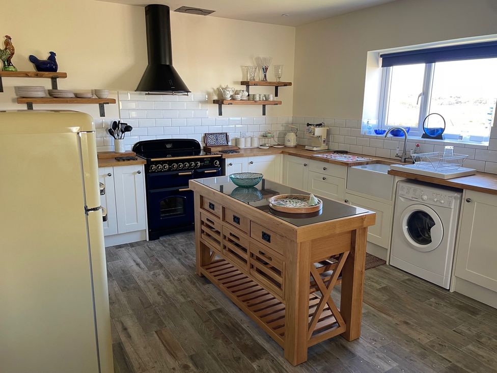 A kitchen with appliances and a central island at Country Retreat Sleeps 2 Holyhead