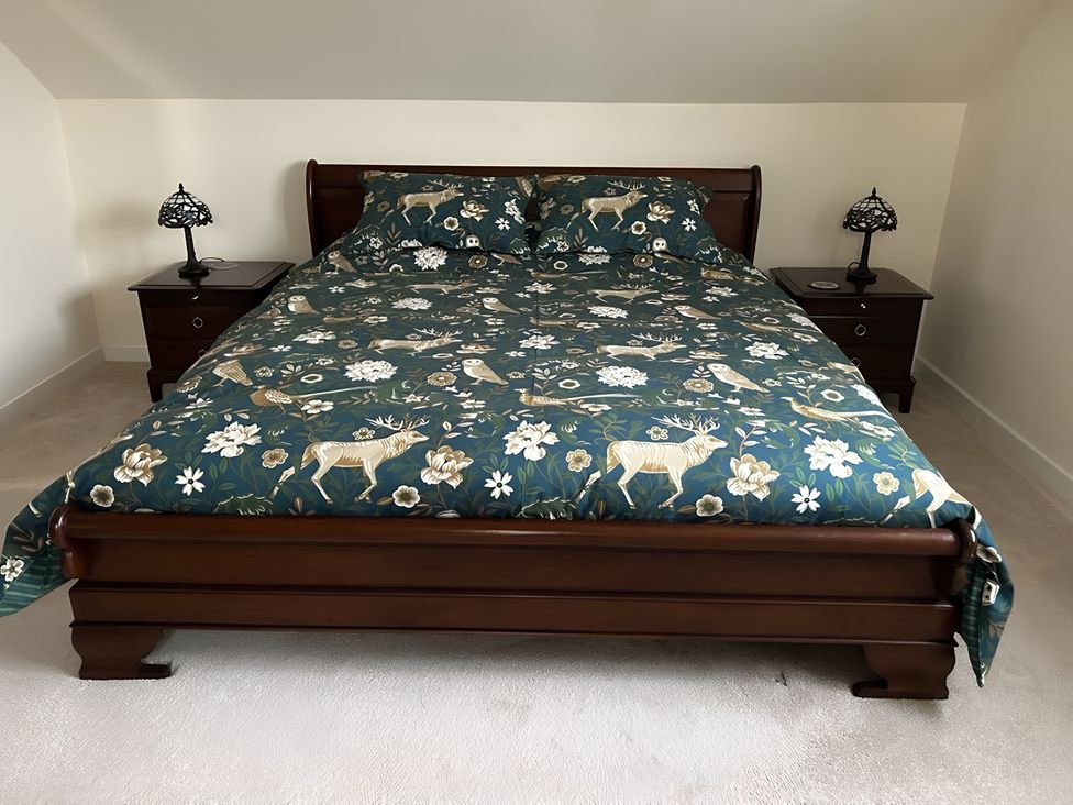 A bedroom with a bed and nightstands at Country Retreat Sleeps 2 Holyhead