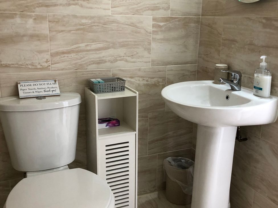 A bathroom with a toilet and sink at Country Retreat Sleeps 2 in Holyhead