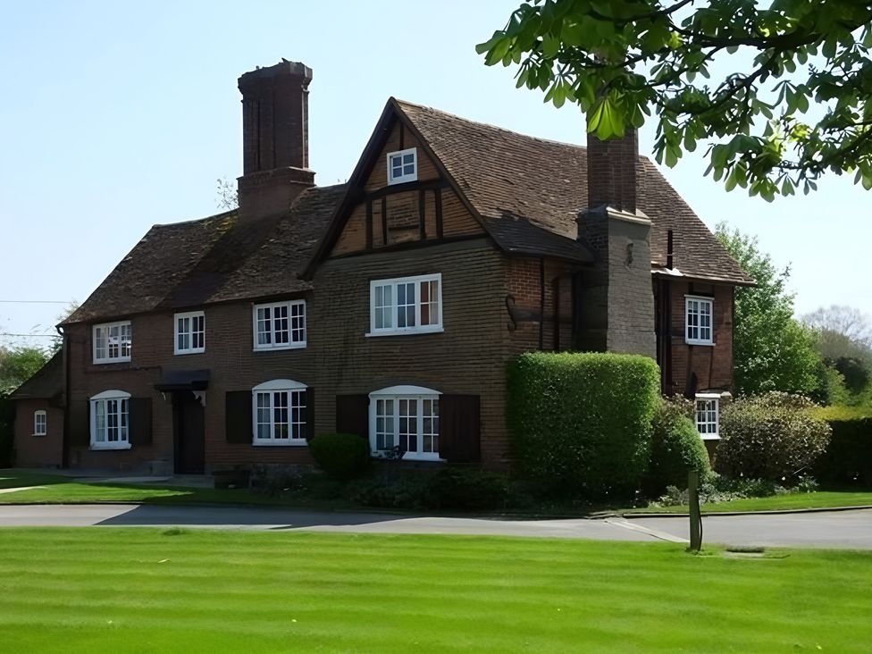 A house with a chimney and windows in Tring