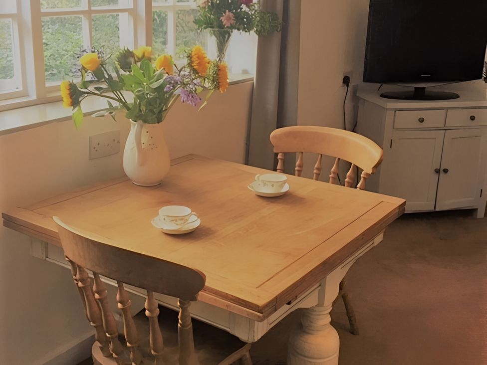 A dining room with a table and chairs at Loxley Barn in Tring