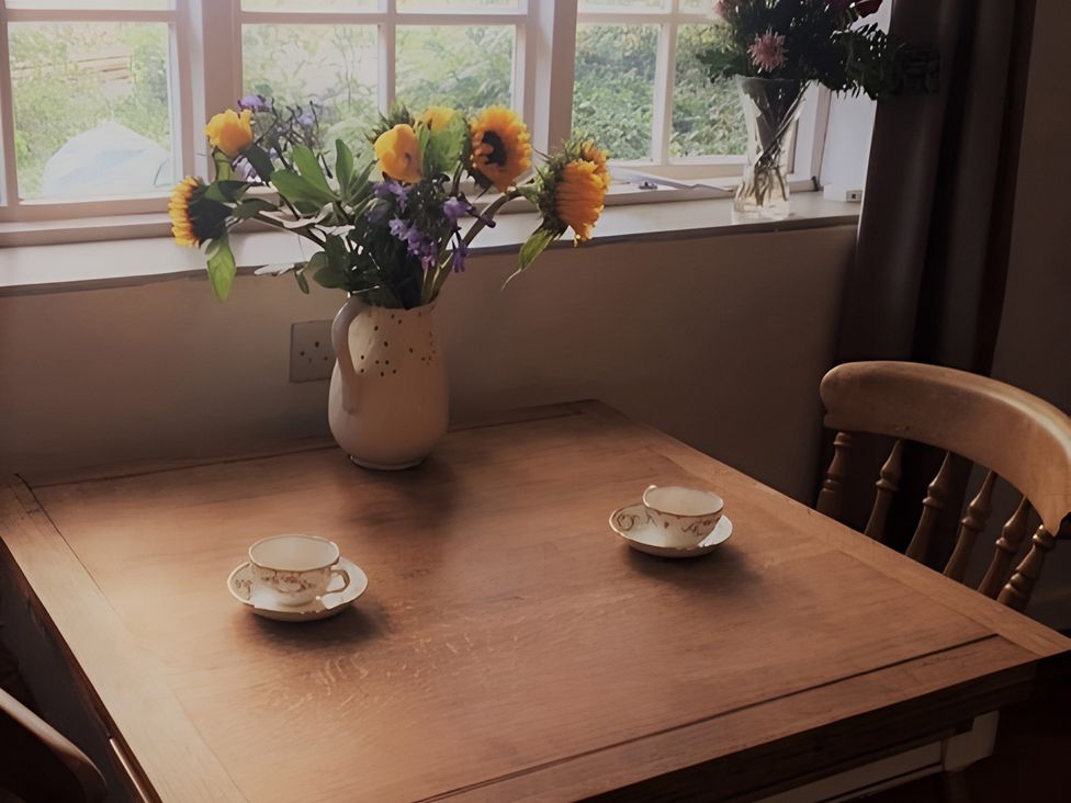 A dining room with a table set for tea at Loxley Barn in Tring