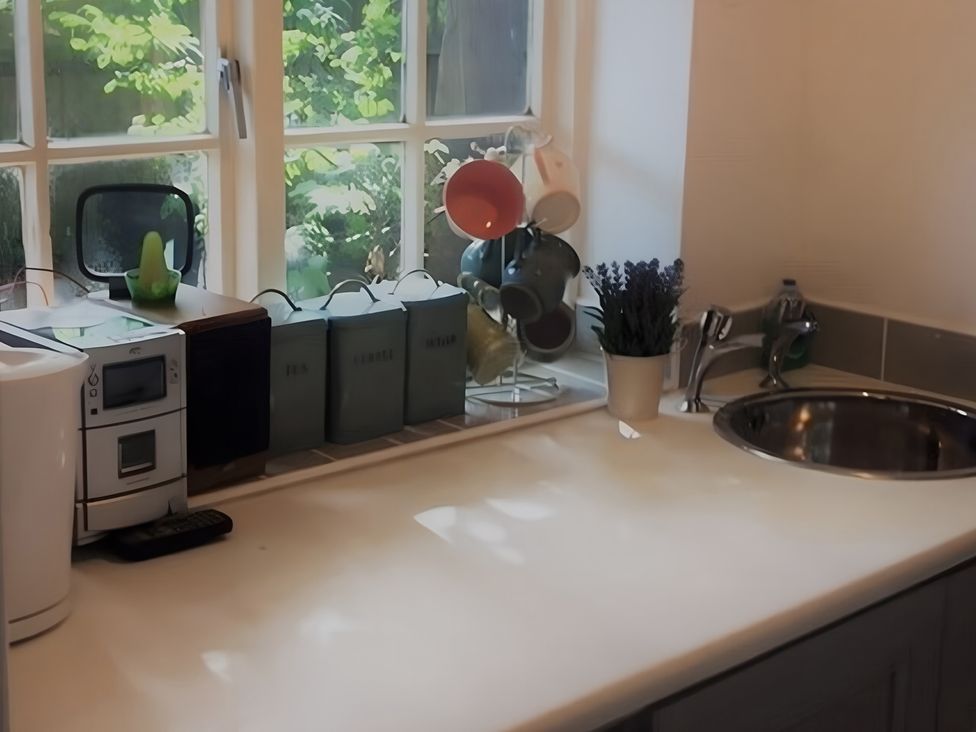 A kitchen with a sink and microwave at Loxley Barn Tring