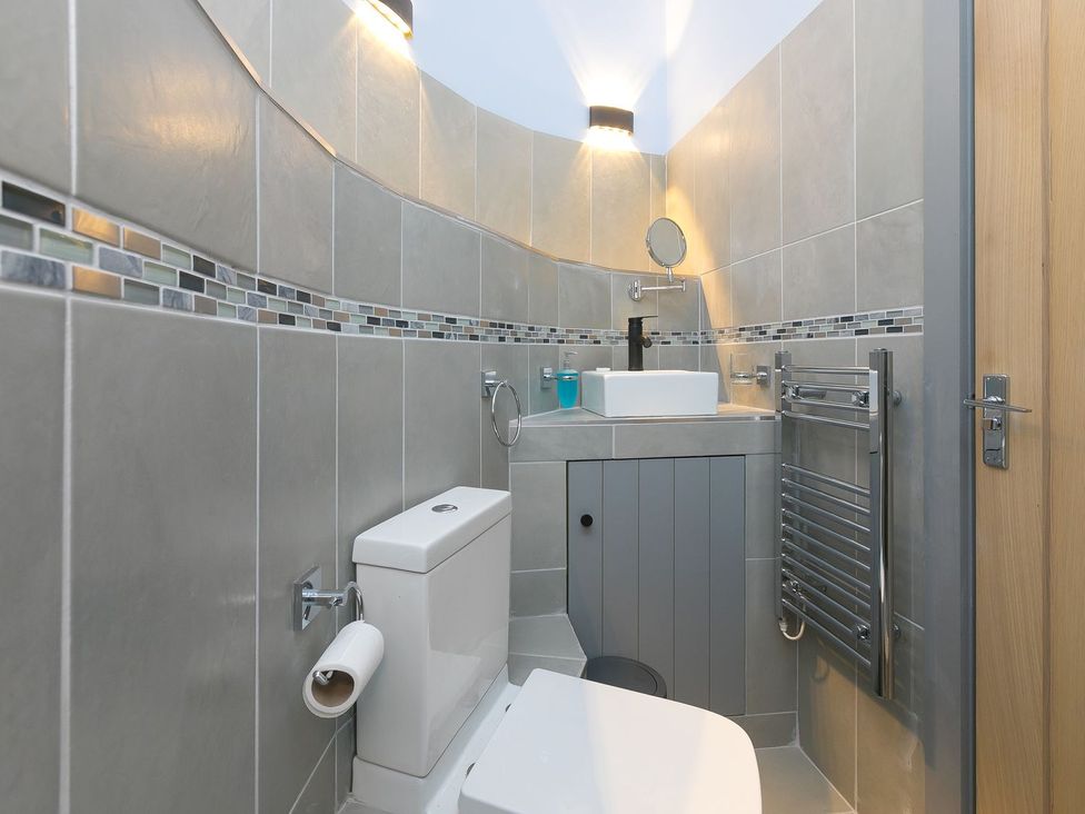 A bathroom with a sink and toilet at The Old Well House in Redruth