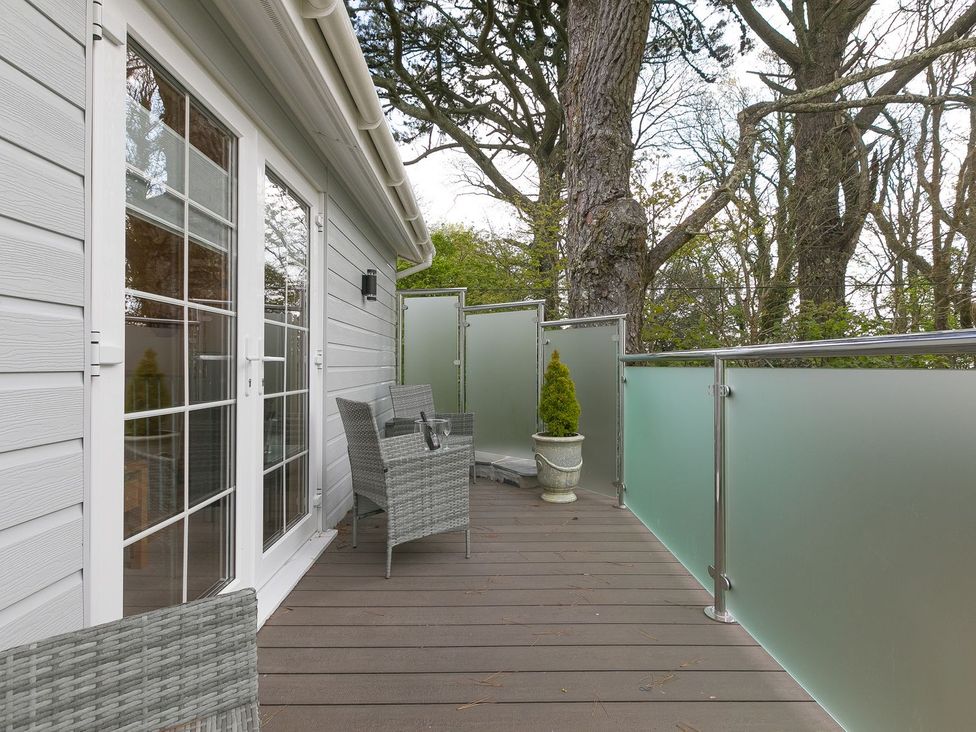 A balcony with chairs and a planter at The Old Well House in Redruth