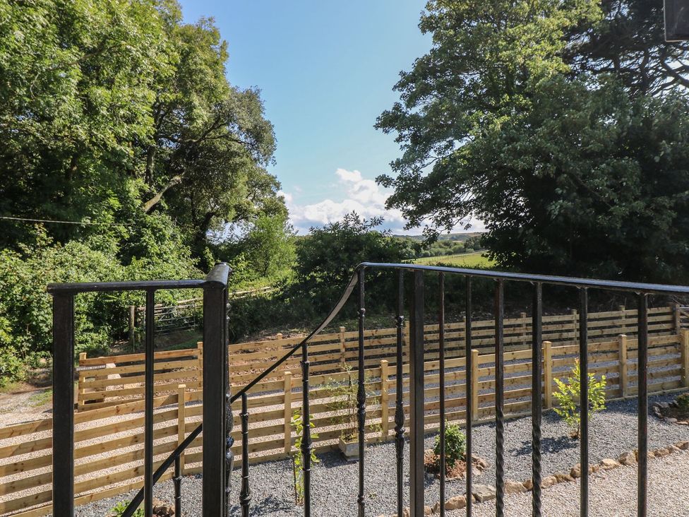 An outdoor area with railings and a gravel path at The Old Well House in Redruth
