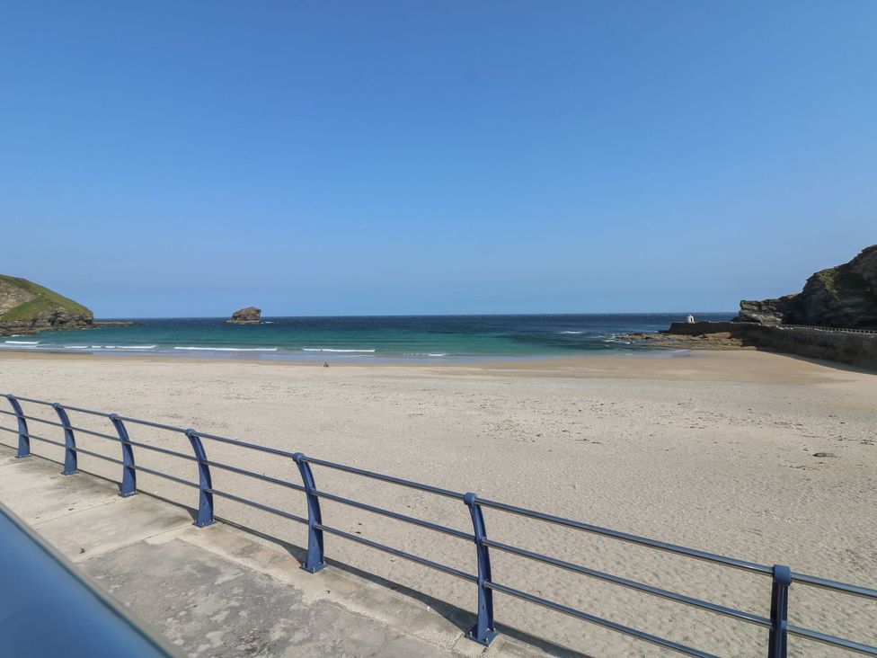 A beach with sand and ocean at The Old Well House in Redruth