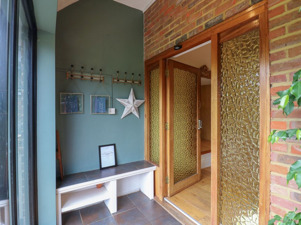A hallway with coat hooks and a bench at Denmark House in Chatham, Kent