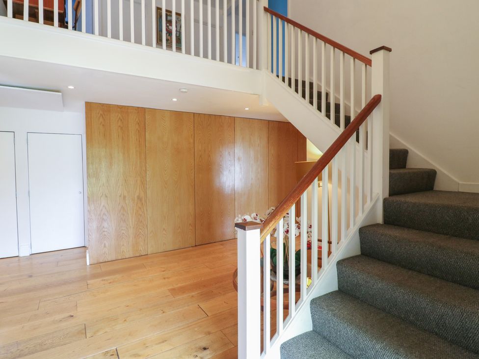 A hallway with staircase and wooden wall panels at Denmark House, Chatham, Kent