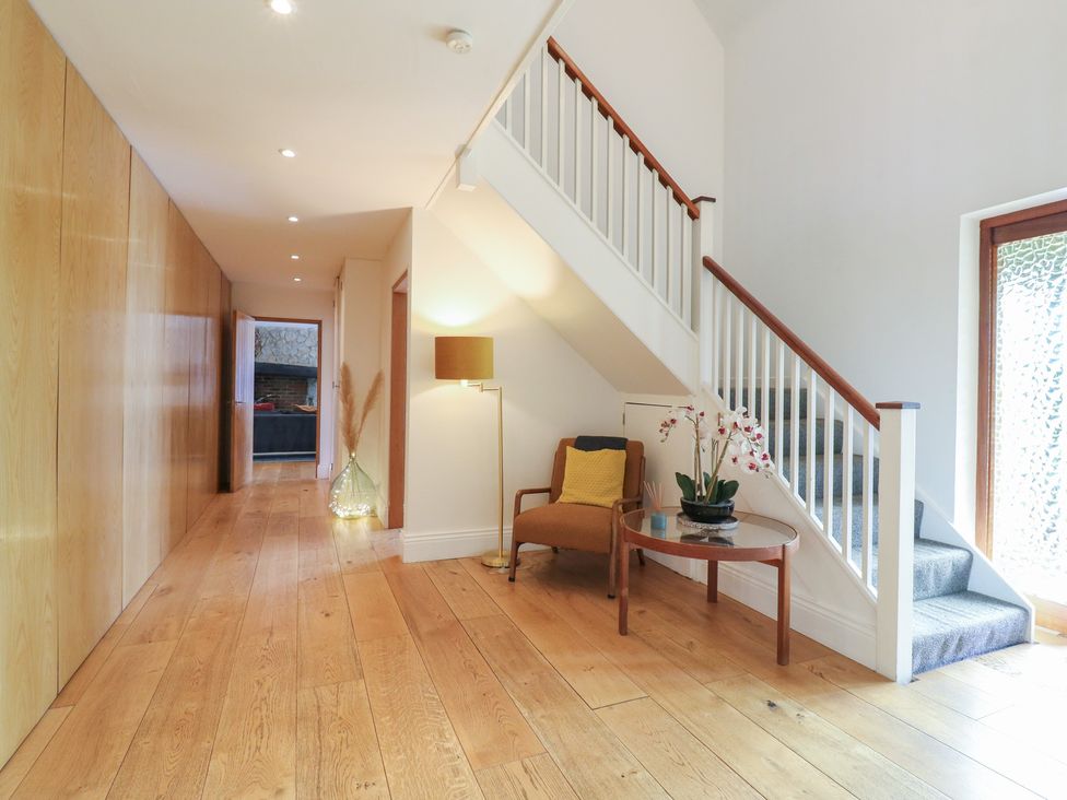 A hallway with a staircase and a table at Denmark House in Chatham, Kent