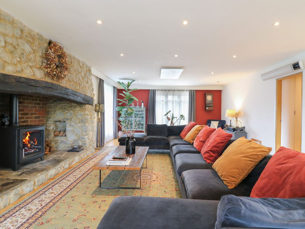 A living room with a fireplace and sofa at Denmark House in Chatham, Kent