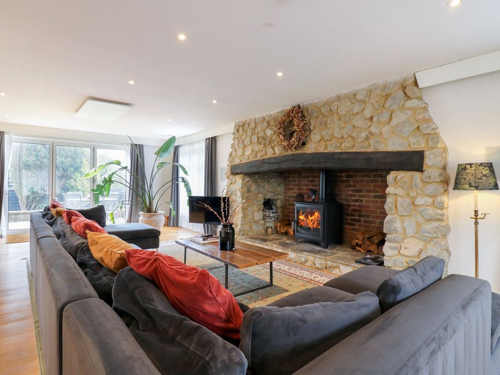A living room with a fireplace and sofa at Denmark House in Chatham, Kent