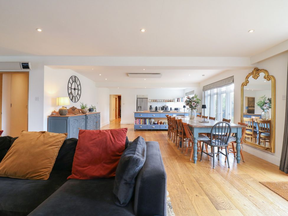 A living room with a sofa, dining table and kitchen appliances at Denmark House in Chatham, Kent