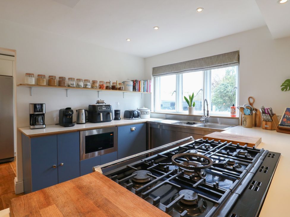 A kitchen with various appliances and a window at Denmark House in Chatham, Kent