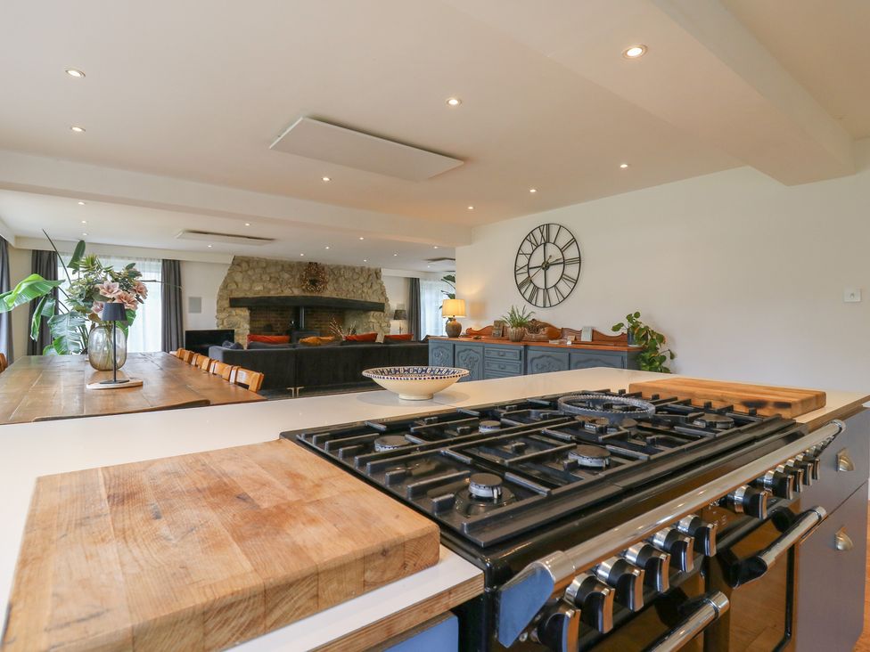 A kitchen with a stove and dining area at Denmark House Chatham, Kent