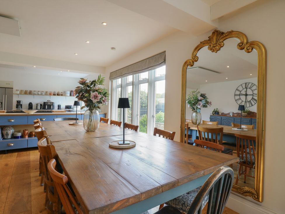 A dining room with a large table and chairs at Denmark House in Chatham, Kent