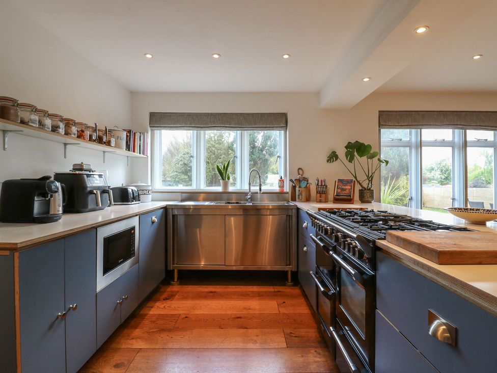 A kitchen with sink and stove at Denmark House in Chatham, Kent