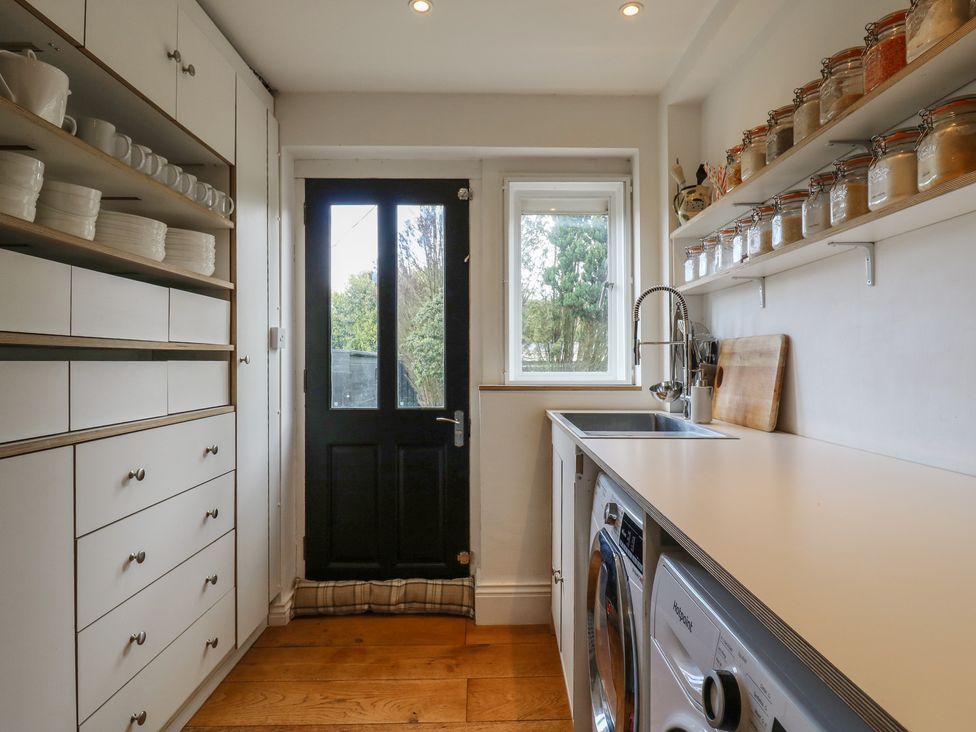 A kitchen with storage shelves and a sink at Denmark House in Chatham, Kent