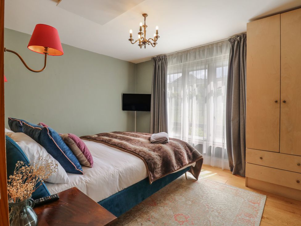 A bedroom with a bed and television at Denmark House in Chatham, Kent