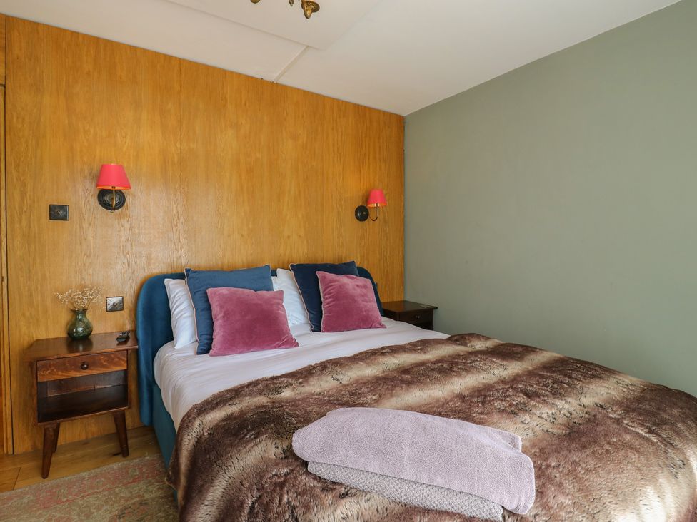 A bedroom with a bed and nightstand at Denmark House, Chatham, Kent