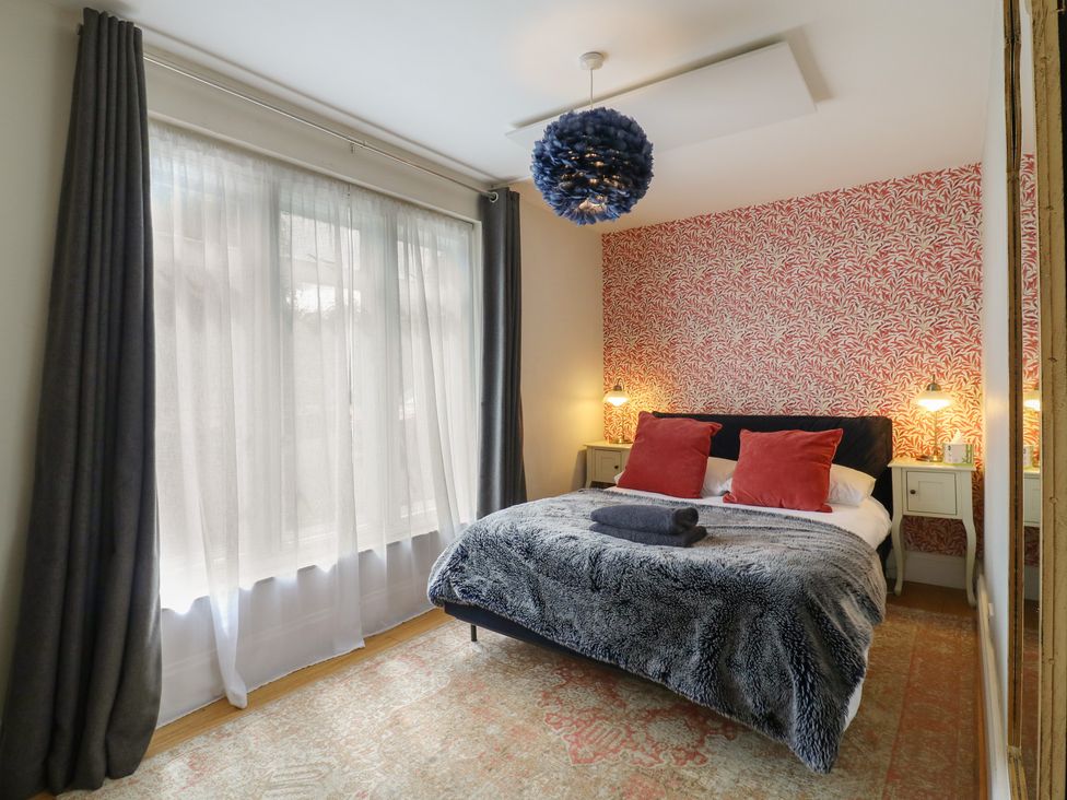 A bedroom with a bed and bedside tables at Denmark House in Chatham, Kent