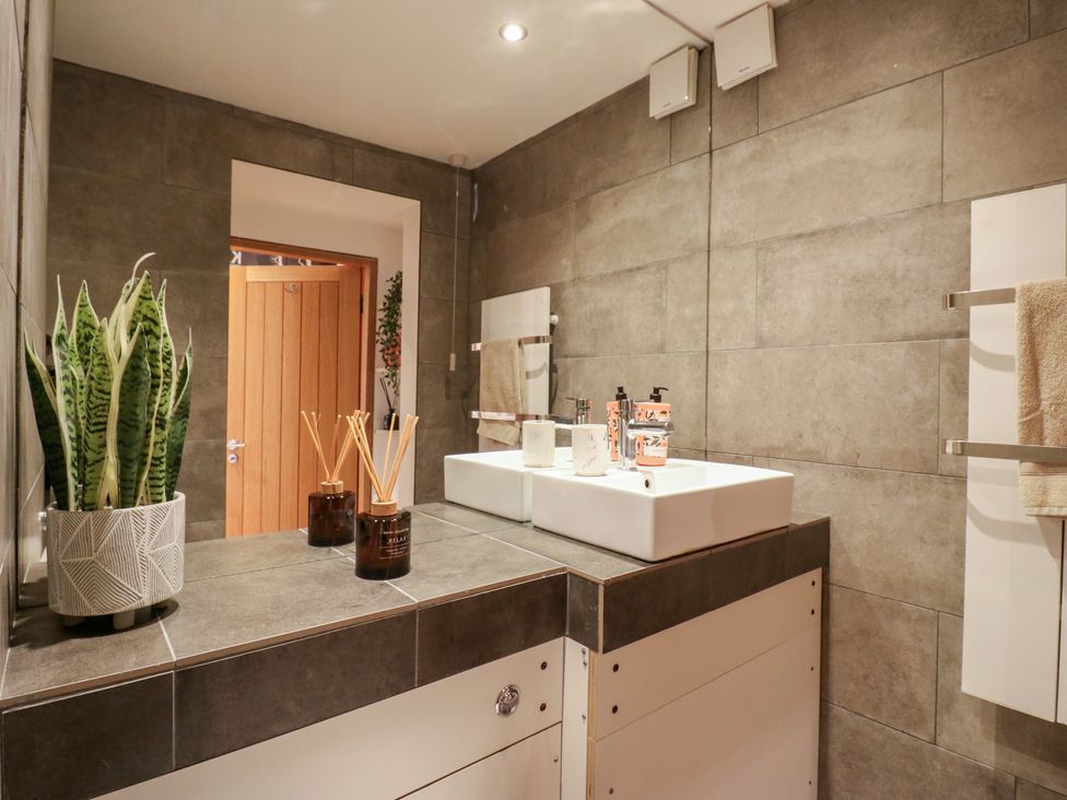 A bathroom with a sink and houseplant at Denmark House Chatham, Kent