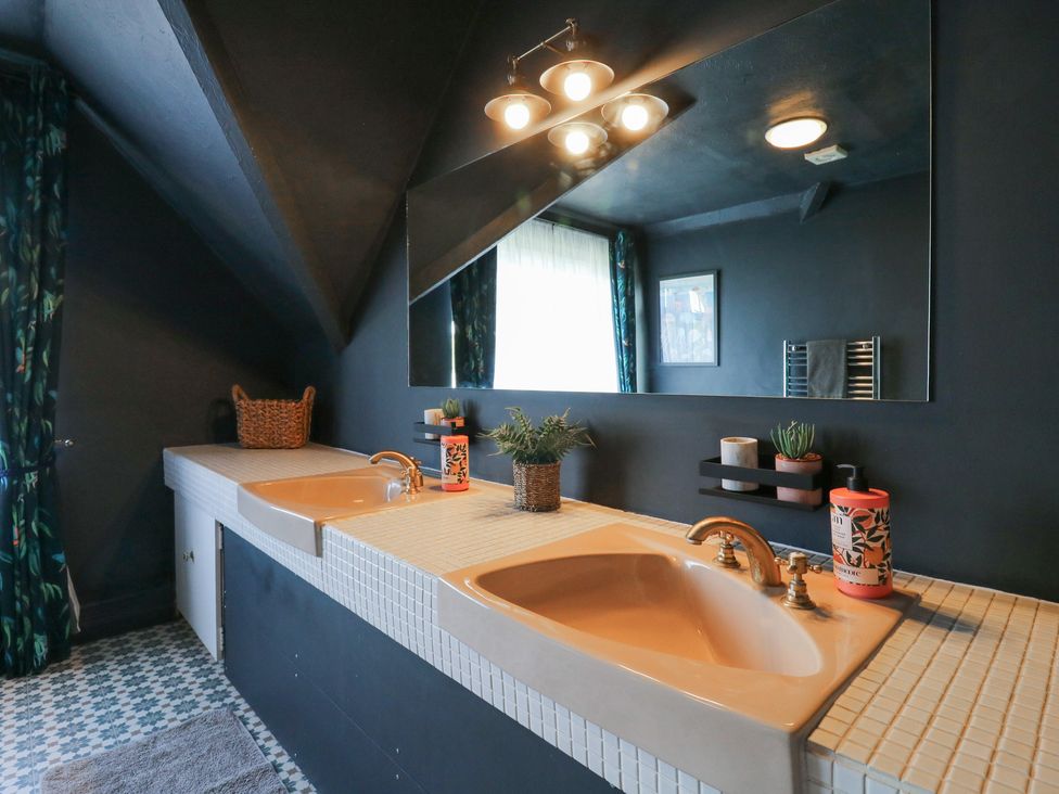 A bathroom with sinks and a mirror at Denmark House, Chatham, Kent