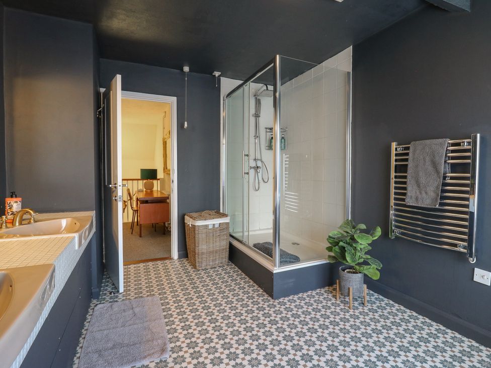 A bathroom with a shower and bathtub at Denmark House in Chatham, Kent