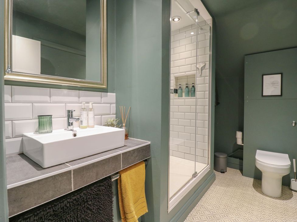 A bathroom with a sink, shower, and toilet at Denmark House in Chatham, Kent
