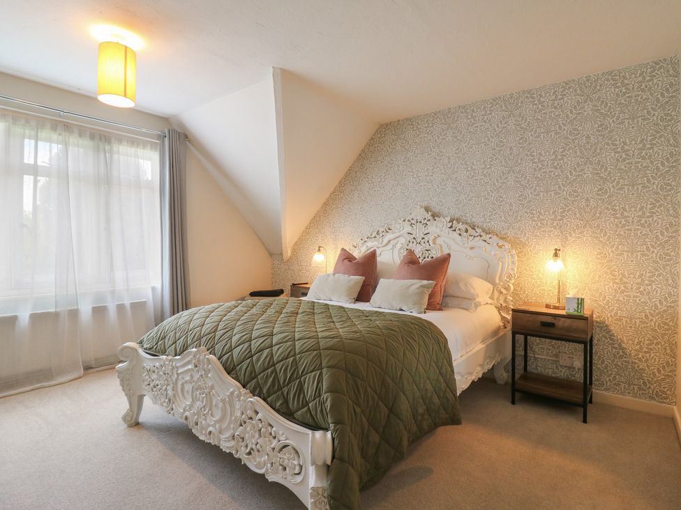 A bedroom with a bed and bedside table at Denmark House in Chatham, Kent