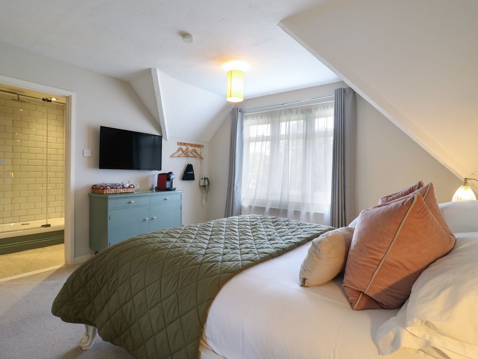 A bedroom with a bed and television at Denmark House in Chatham, Kent