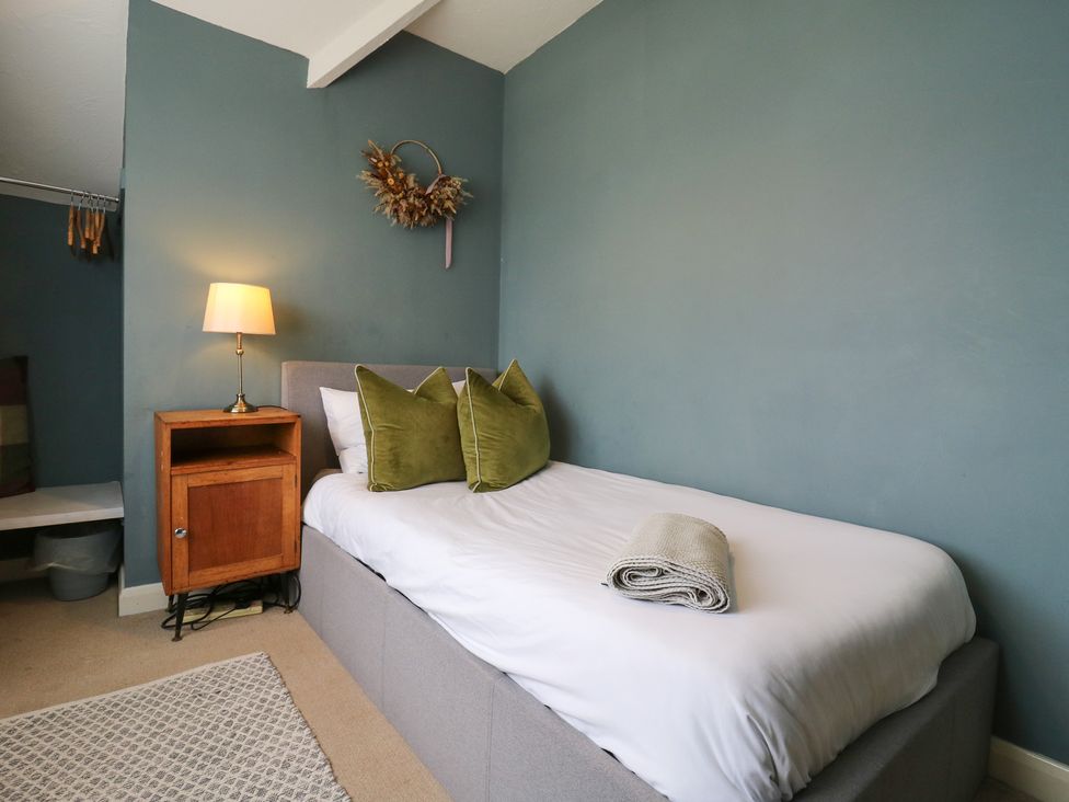 A bed with pillows and a lamp in a bedroom at Denmark House in Chatham, Kent