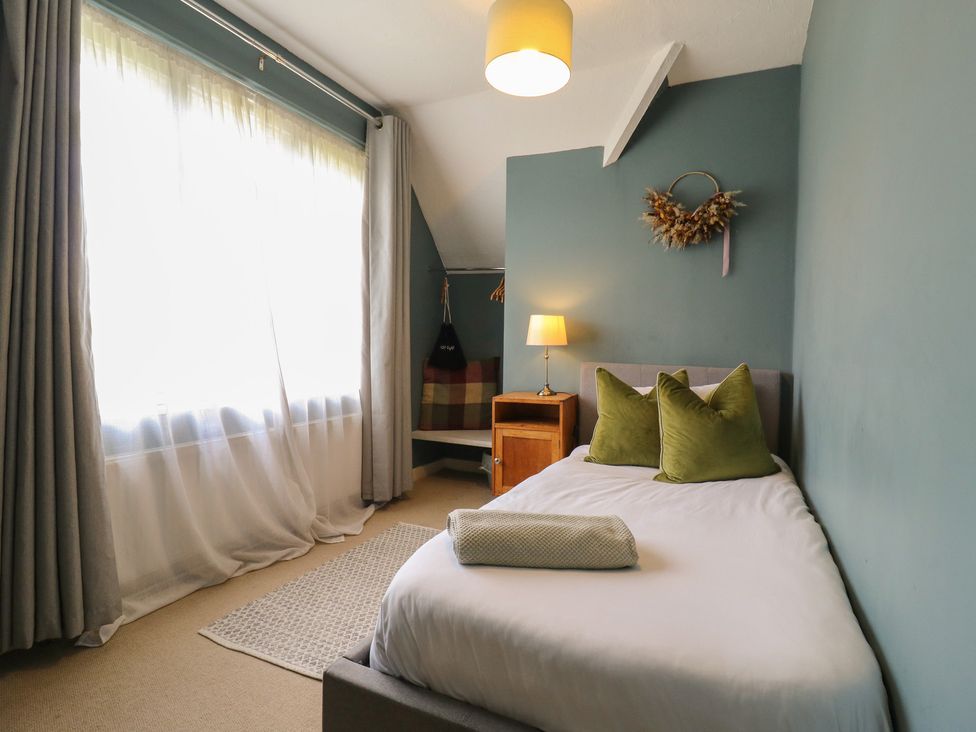 A bedroom with a bed and a nightstand at Denmark House in Chatham, Kent