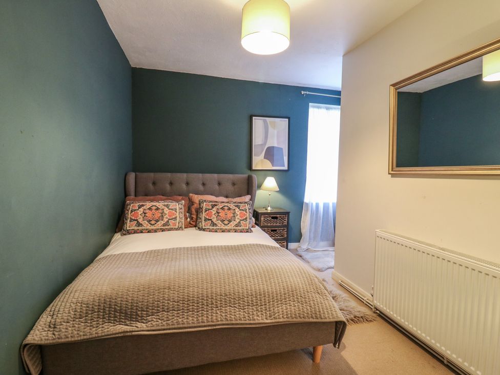A bedroom with a bed and lamp at Denmark House in Chatham, Kent