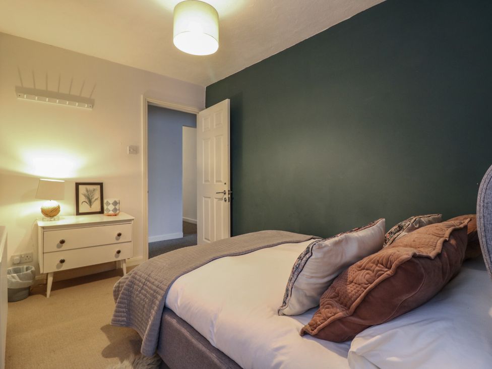 A bedroom with a bed and bedside table at Denmark House in Chatham, Kent