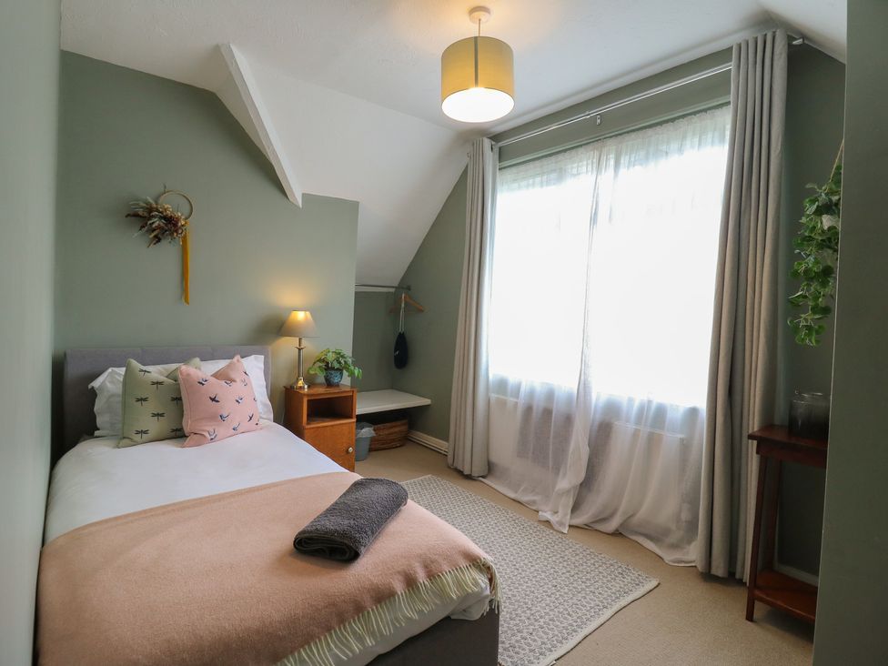 A bedroom with a bed and window at Denmark House in Chatham, Kent