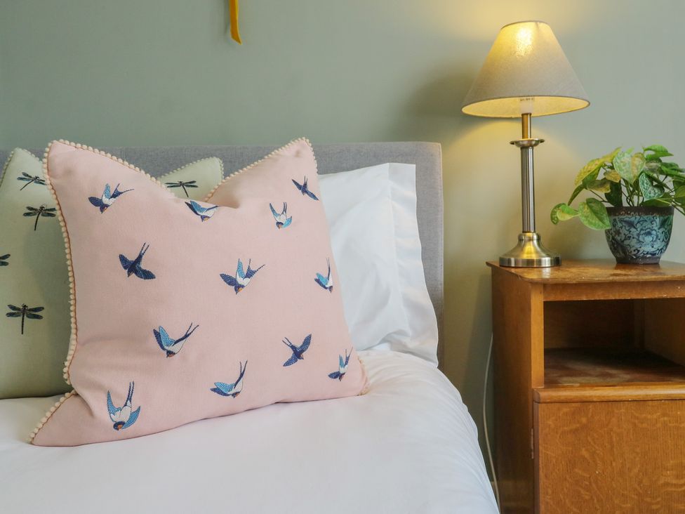 A bedroom with pillows and a lamp at Denmark House in Chatham, Kent