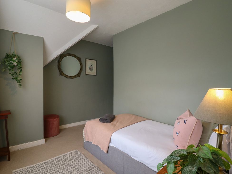 A bedroom with a bed and lamp at Denmark House in Chatham, Kent