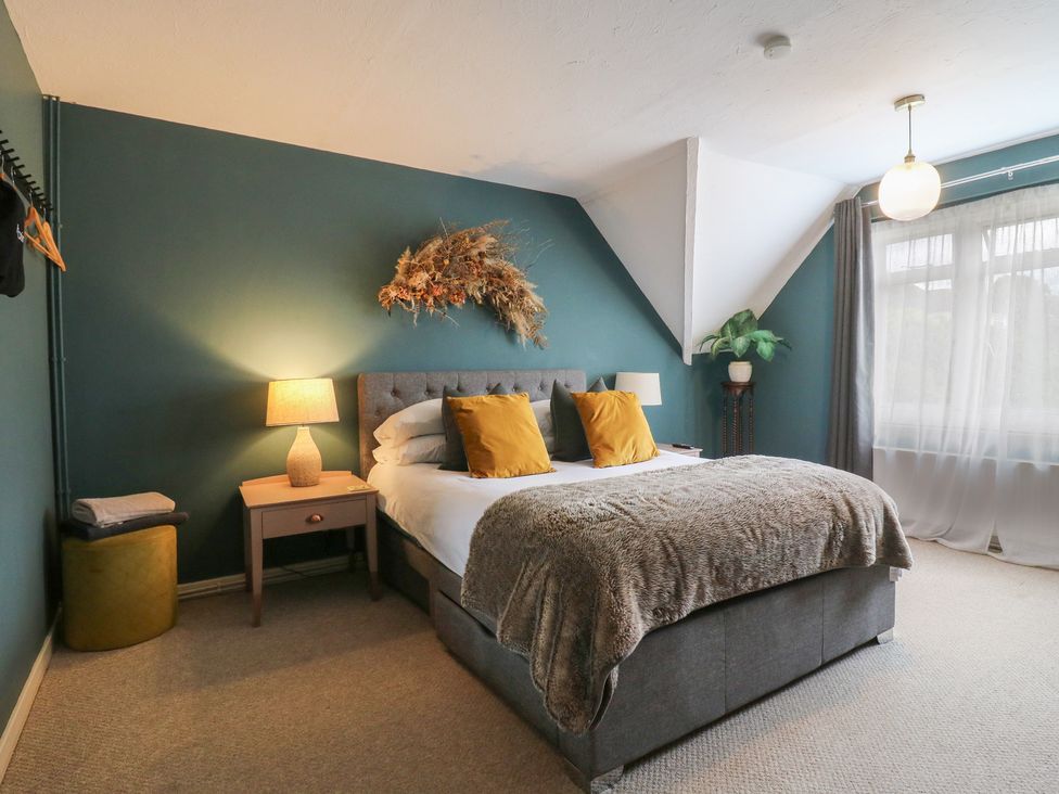 A bedroom with a bed and lamp at Denmark House, Chatham, Kent