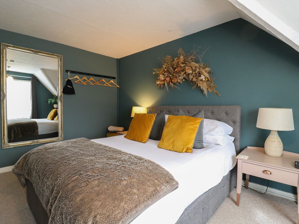 A bedroom with a bed and decorative wall art at Denmark House in Chatham, Kent