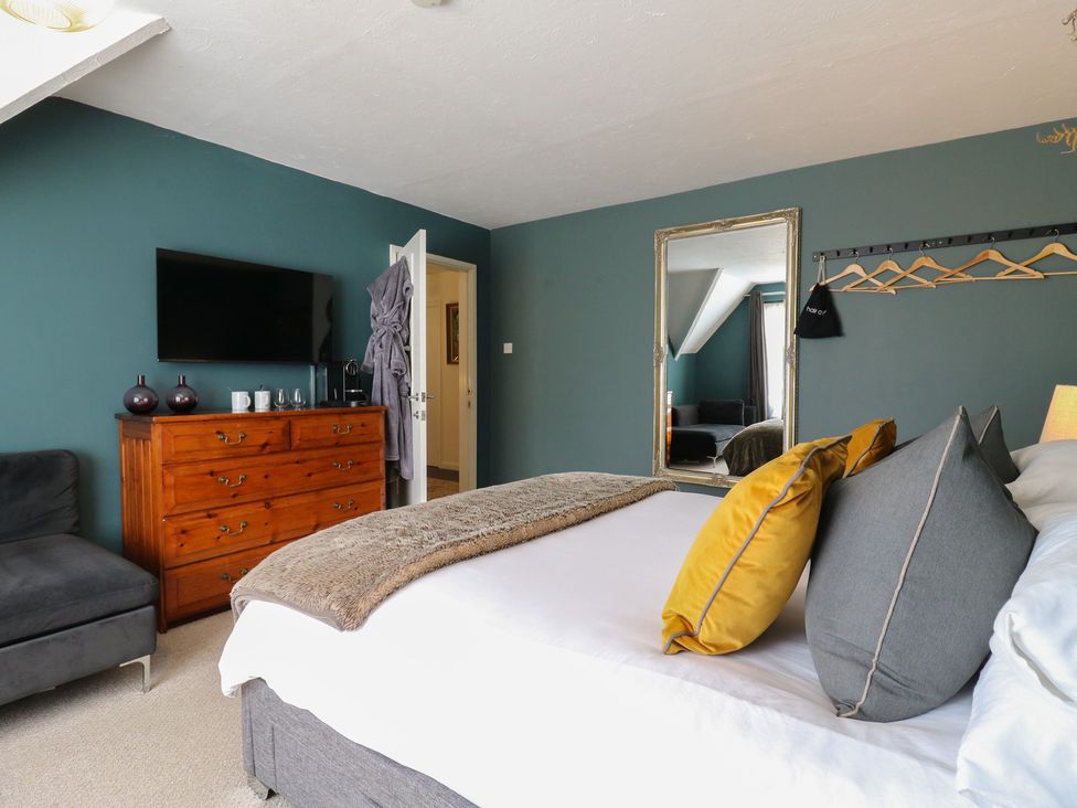 A bedroom with a bed and television at Denmark House in Chatham, Kent