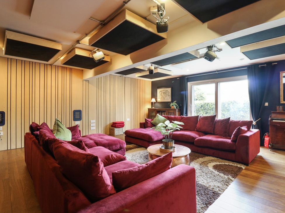 A living room with a red sofa and coffee table at Denmark House in Chatham, Kent