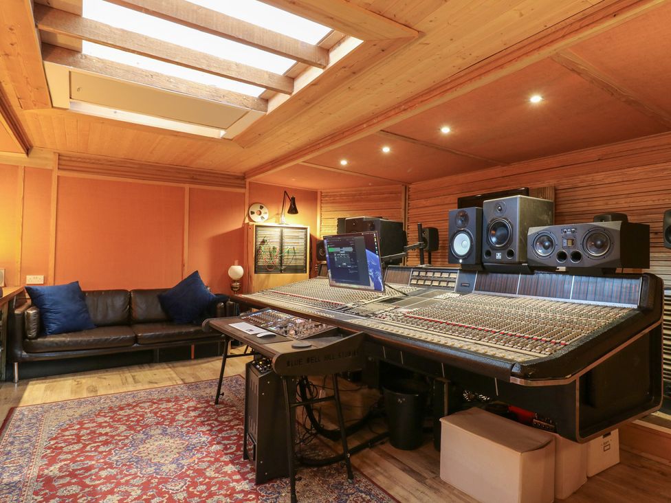 A music studio with a mixing console and monitor speakers at Denmark House in Chatham, Kent