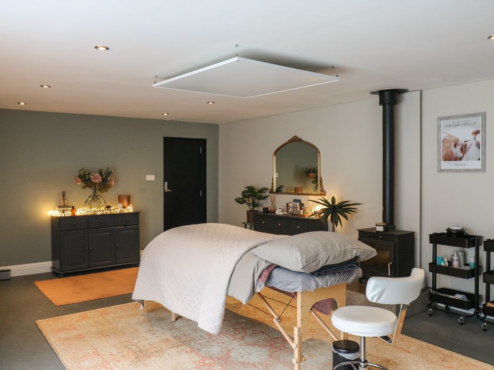 A treatment room with a massage table and cabinet at Denmark House in Chatham, Kent