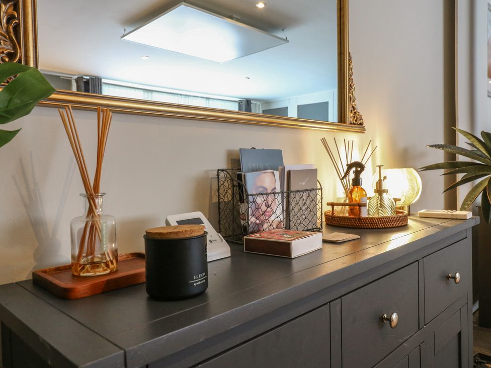 A console table with decorative items in the living room at Denmark House Chatham, Kent