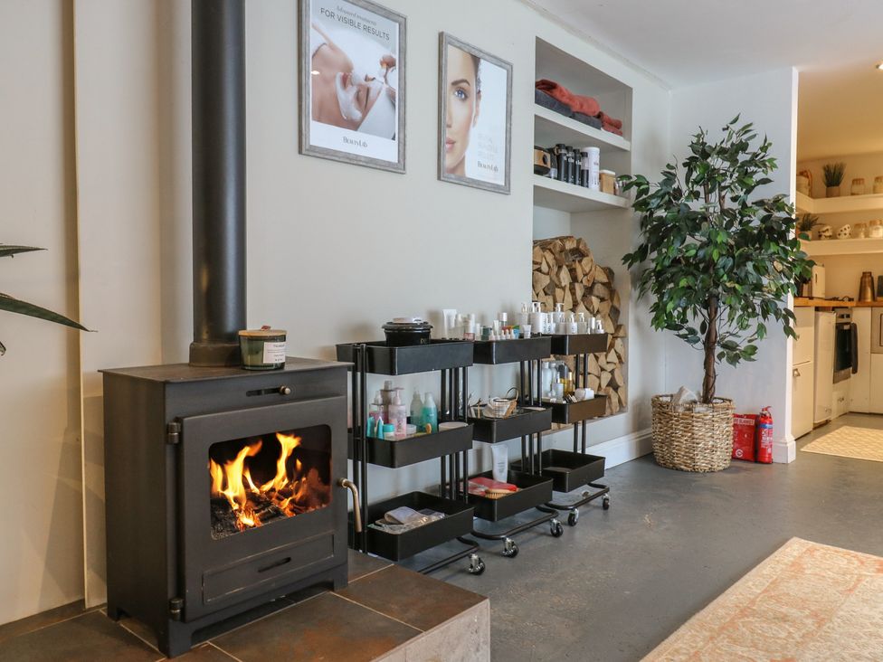 A snug with a wood stove and skincare products at Denmark House in Chatham, Kent